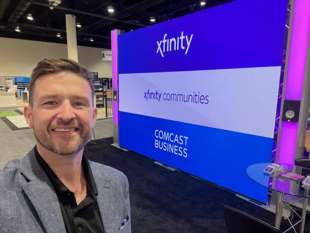 Chris Arsenault at an Xfinity Communities and Comcast Business trade show booth